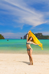 Young woman with sarong on the beach