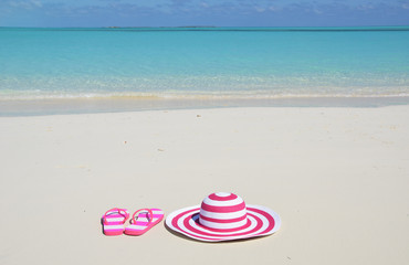 Flip-flops and hat on the beach of Exuma, Bahamas