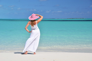 Girl in the hat on the beach of Exuma, Bahamas