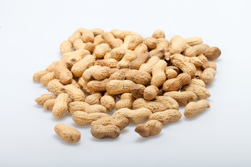 .Dried peanuts in closeup on the white background