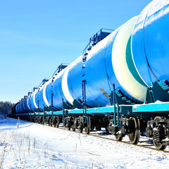 blue cargo train on the move in winter