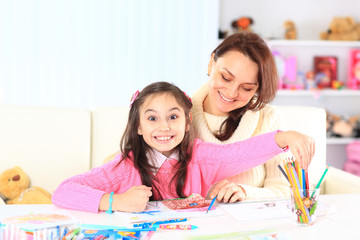 Fototapeta premium Beautiful girl draws with his mother