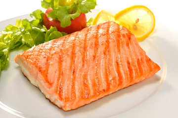 grilled salmon with vegetables on white plate