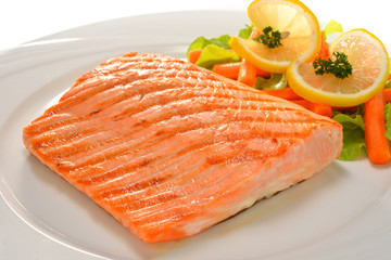 grilled salmon with vegetables on white plate
