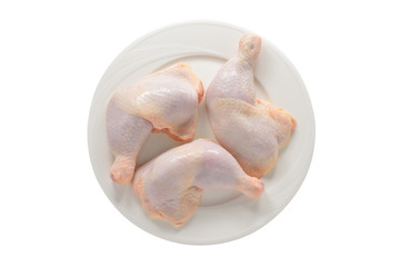 fresh chicken thighs on white plate