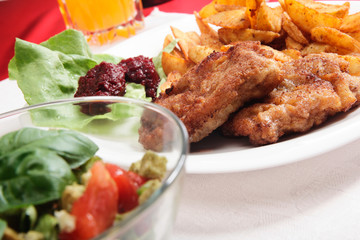 Breaded chop and prepared potatos