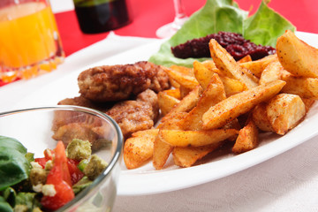 Breaded chop and prepared potatos