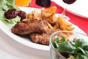 Breaded chop and prepared potatos