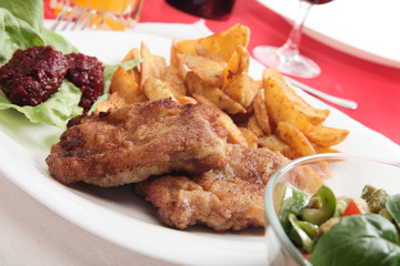 Breaded chop and prepared potatos