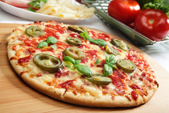 Pizza with cheese, ham and jalapeno pepper