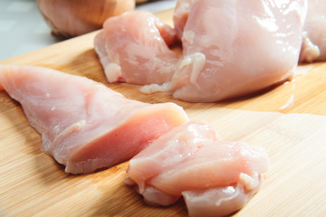 Raw chicken breast on cutboard