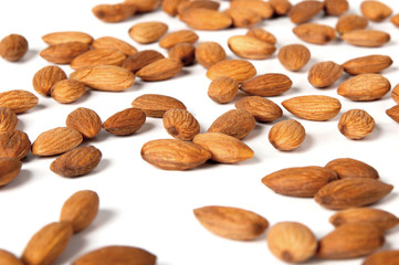 Seed of almonds nuts over white