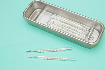 Pile of medical thermometer in tray