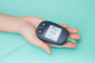Hand with glucometer
