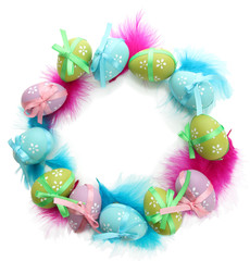 Wreath of bright easter eggs and decorative feathers, isolated