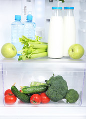 Open refrigerator with vegetarian food