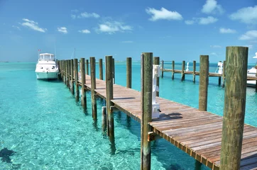 Fotobehang Yacht at the wooden jetty. Exuma, Bahamas © HappyAlex