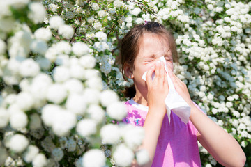 Little girl is blowing her nose