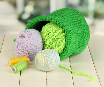 Colorful yarn for knitting in green basket