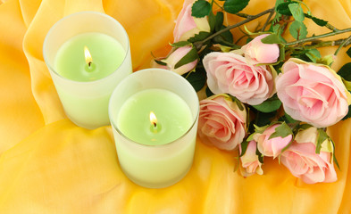 Candles on a yellow fabric close-up