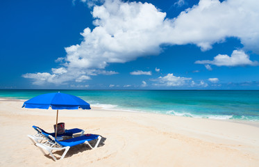 Fototapeta na wymiar Chairs and umbrella on tropical beach