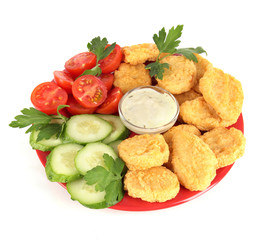 Fried chicken nuggets with vegetables and sauce isolated