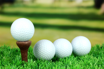 Golf balls on grass outdoor close up