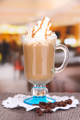 Layered coffee in glass on table on bright background
