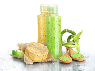 Bottles with scrub and hand-made soap, isolated on white