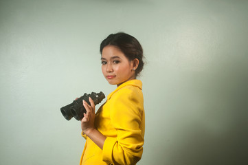 Pretty Asian business woman holding  binoculars.
