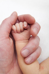 hold a hand of the newborn child