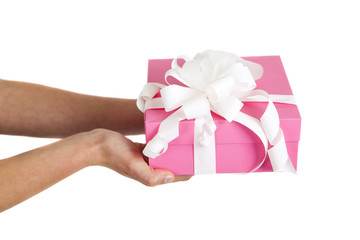pink gift box with white ribbon in woman hands