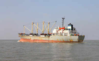 Old industrial product ship head to wide sea.