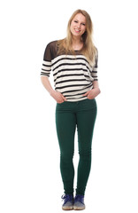 Portrait of a beautiful young woman with hands in pockets