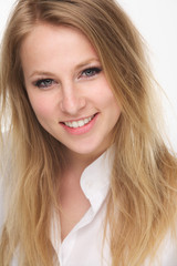 Close up portrait of a beautiful young blond woman smiling