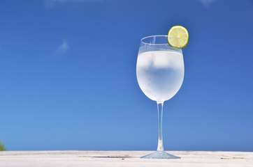 Glass of water against blue sky