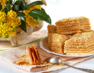 still life with yellow flowers and a cake