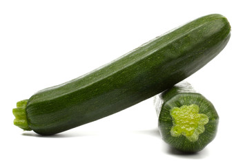 Two fresh vegetable zucchini isolated on white background