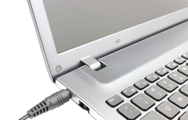 Plug adapter being connected to laptop computer