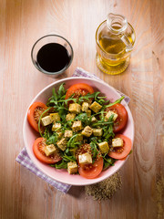 salad with tofu tomatoes arugula and sesame seeds