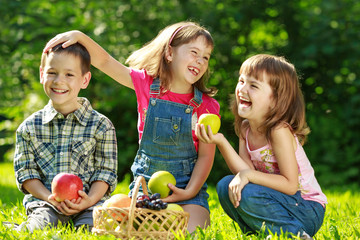 Three happy smiling child playing in park