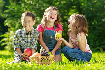 Three happy smiling child playing in park