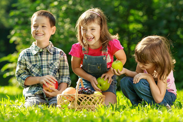 Three happy smiling child playing in park