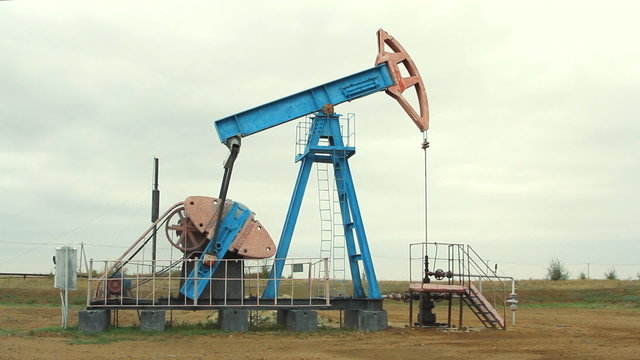 Oil and gas industry. Work of oil pump jack on a oil field.