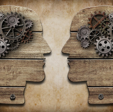Two human head silhouettes with cogs and gears