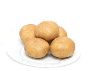 fresh potatoes on the plate on white background