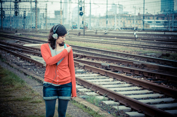 Beautiful stylish woman listening to music
