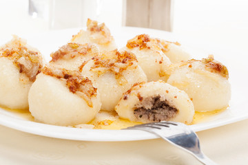 Meat stuffed dumplings with fried onion. Selective focus