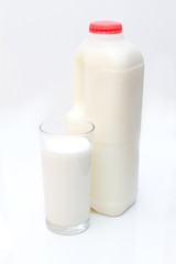 glass of milk with carton behind