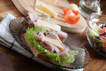 Sandwiches with cheese, ham and lettuce. Dark tone